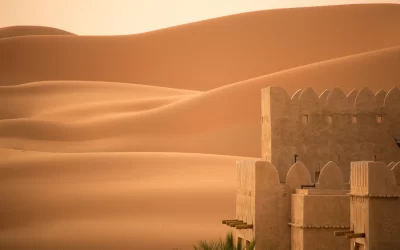 Arabic castle tower shot against the desert in the early morning sun, Abu Dhabi in the Liwa Desert