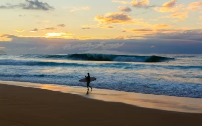 beach at the North Shore of Oahu, Hawaii, with an unrecognizable surfer